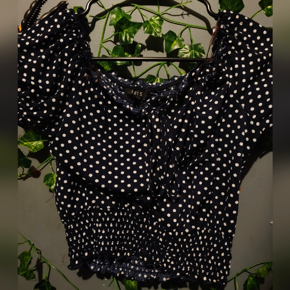 Blue cropped top with white polka dots.
